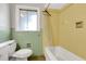 Retro style bathroom with green and yellow tile, tub and shower combo at 1405 Pinehurst Sw Dr, Atlanta, GA 30311