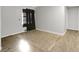 A bedroom with grey walls, wood-look floors, and a window at 1405 Pinehurst Sw Dr, Atlanta, GA 30311