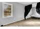 An empty bedroom with wood-look floors, grey walls, and a window at 1405 Pinehurst Sw Dr, Atlanta, GA 30311