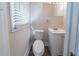 Bathroom with white fixtures, a sink, a toilet, and a mirror at 16 Bromack Se Dr, Atlanta, GA 30315