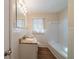 Bathroom with white fixtures, new flooring, and a tiled shower at 16 Bromack Se Dr, Atlanta, GA 30315