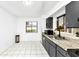 Efficient kitchen with granite countertops and gray cabinets at 25 Quail Run, Decatur, GA 30035