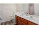 Bathroom with double sinks, wooden cabinets, large mirror, and stylish fixtures at 2637 Cedar Dr, Lawrenceville, GA 30043