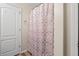 Bright bathroom with a patterned shower curtain and white door at 2637 Cedar Dr, Lawrenceville, GA 30043