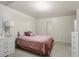 Well-lit bedroom with a queen bed and ensuite access at 2637 Cedar Dr, Lawrenceville, GA 30043