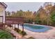 Community pool with deck and wooded backdrop at 2637 Cedar Dr, Lawrenceville, GA 30043