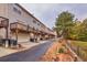 Exterior view of townhomes with private garages, balconies, and lush greenery at 2637 Cedar Dr, Lawrenceville, GA 30043