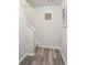 Hallway featuring wood floors and the bottom portion of a carpeted staircase at 2637 Cedar Dr, Lawrenceville, GA 30043