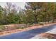 Street view of road bordered by a wooden fence and mature trees at 2637 Cedar Dr, Lawrenceville, GA 30043