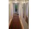 Long hallway with hardwood floors, mirrors, and access to bedrooms at 3825 Lavista Rd # O3, Tucker, GA 30084