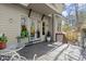 Inviting back porch with double doors, outdoor seating, potted plants, and natural light perfect for relaxing at 105 Weatherford Pl, Roswell, GA 30075