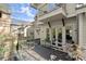 Spacious back porch with cozy seating, offering a scenic view and an ideal spot for outdoor relaxation at 105 Weatherford Pl, Roswell, GA 30075