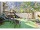 Green backyard with artificial grass, featuring an outdoor seating area and surrounded by plants at 105 Weatherford Pl, Roswell, GA 30075