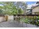Backyard featuring outdoor seating on a wooden deck surrounded by lush greenery, perfect for entertaining at 105 Weatherford Pl, Roswell, GA 30075