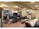 Finished basement with multiple seating options, exercise equipment, and bookcase at 105 Weatherford Pl, Roswell, GA 30075