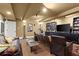 Finished basement with multiple seating options, exercise equipment, and large TV at 105 Weatherford Pl, Roswell, GA 30075
