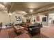 Finished basement with multiple seating options, exercise equipment, and a dart board at 105 Weatherford Pl, Roswell, GA 30075