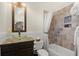 Elegant bathroom featuring a glass vessel sink, mosaic countertop, and tiled shower with stone accent at 105 Weatherford Pl, Roswell, GA 30075