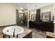 Elegant bathroom featuring a soaking tub, walk-in shower with unique tile, and double vanities at 105 Weatherford Pl, Roswell, GA 30075
