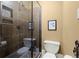 Bathroom showcases a glass-enclosed shower with tiled walls, alongside a sleek toilet for a functional design at 105 Weatherford Pl, Roswell, GA 30075