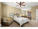 Cozy bedroom with neutral tones, featuring a wrought iron bed frame and comfortable armchair at 105 Weatherford Pl, Roswell, GA 30075