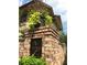 Weatherford Place entrance with a brick pillar and lush plants creates a welcoming and attractive neighborhood entry at 105 Weatherford Pl, Roswell, GA 30075
