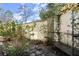 Private courtyard with stone pathway, wrought iron bench, and lush plants at 105 Weatherford Pl, Roswell, GA 30075