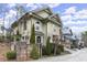 Beautiful home exterior with lush landscaping, a brick fence, and architectural details for an inviting curb appeal at 105 Weatherford Pl, Roswell, GA 30075