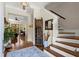 Inviting foyer with hardwood floors, staircase, stylish decor, and view into a sitting area at 105 Weatherford Pl, Roswell, GA 30075