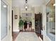Elegant foyer with hardwood floors, decorative lighting, and a view into the home's open layout at 105 Weatherford Pl, Roswell, GA 30075