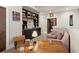 Comfortable home office featuring dark wood bookshelves, desk, and a cozy pink sofa at 105 Weatherford Pl, Roswell, GA 30075