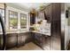 Well-equipped kitchen with dark wood cabinets and tile backsplash at 105 Weatherford Pl, Roswell, GA 30075