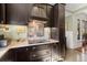 Kitchen features dark wood cabinets, granite counters, and a gas cooktop at 105 Weatherford Pl, Roswell, GA 30075