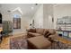 Bright living room featuring a plush sectional sofa, wood floors, and large windows at 105 Weatherford Pl, Roswell, GA 30075