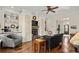 Cozy living room with a fireplace, built-in shelves, hardwood floors, and a comfortable seating area at 105 Weatherford Pl, Roswell, GA 30075