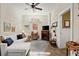Bright living room with a white sofa, fireplace, and unique glass coffee table at 105 Weatherford Pl, Roswell, GA 30075