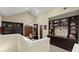 Loft featuring built-in bookshelves, a seating area, natural light, and neutral wall color at 105 Weatherford Pl, Roswell, GA 30075