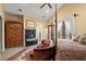 Comfortable bedroom featuring a fireplace, sitting area, closet, and decorative area rug at 105 Weatherford Pl, Roswell, GA 30075