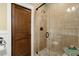 Modern tile shower with pebble floor, glass door, and elegant fixtures at 105 Weatherford Pl, Roswell, GA 30075