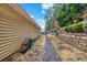 Spacious backyard featuring a rock drainage area and landscaped hillside at 5732 Village Loop, Fairburn, GA 30213