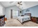 Bright main bedroom featuring vaulted ceilings, a ceiling fan, and a window that offers plenty of natural light at 5732 Village Loop, Fairburn, GA 30213