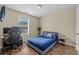 Cozy bedroom features wood-look flooring, a blue bed set, and an entertainment setup at 2555 Flat Shoals Rd # 802, Atlanta, GA 30349