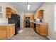 Functional kitchen features wood cabinets, black appliances, and laminate countertops with durable flooring at 2555 Flat Shoals Rd # 802, Atlanta, GA 30349