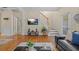 Open-concept living area with hardwood floors, a flatscreen tv, staircase and ample sunlight at 2555 Flat Shoals Rd # 802, Atlanta, GA 30349