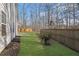 Newly seeded backyard featuring a wood fence for privacy and mature trees for plenty of shade at 3490 Buffington Ln, Cumming, GA 30040