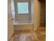 Bright bathroom with a tub, tile flooring, and natural light at 3490 Buffington Ln, Cumming, GA 30040