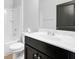 Bathroom with dark wood vanity, white countertop, and shower-tub combo at 3490 Buffington Ln, Cumming, GA 30040
