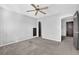 The gray bedroom features plush carpeting, ceiling fan, and brown trim for a contemporary look at 3490 Buffington Ln, Cumming, GA 30040