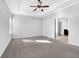 Spacious bedroom features tray ceiling, ceiling fan, and ensuite bathroom at 3490 Buffington Ln, Cumming, GA 30040