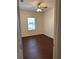 Bedroom with hardwood floors, ceiling fan, and natural light at 3490 Buffington Ln, Cumming, GA 30040